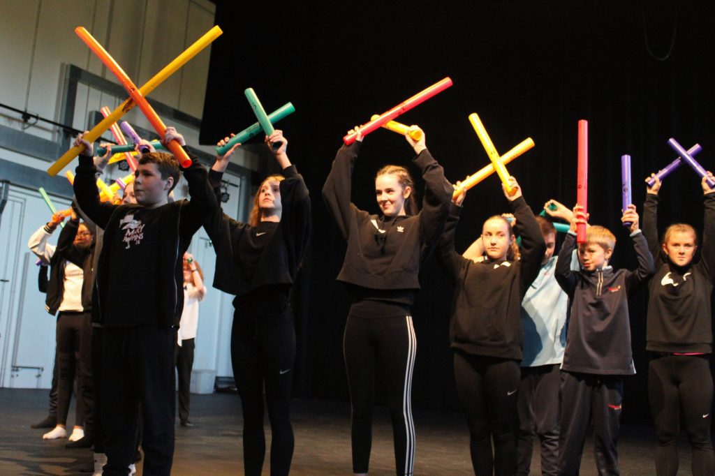 Secondary school students playing boomwhackers 